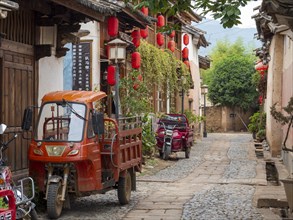 Ancient Chinese houses and tricycle car in the alleys of Shaxi