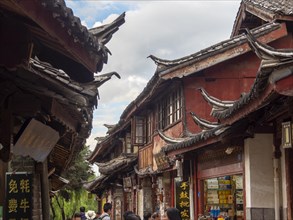 Alleys with old Chinese wooden houses and strolling passers-by