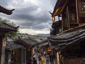Alleys with old Chinese wooden houses and strolling passers-by