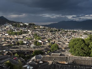View over the Chinese rooftops of the historic old town of Lijiang