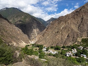 Tibetan village between mountains in the highlands of eastern Tibet