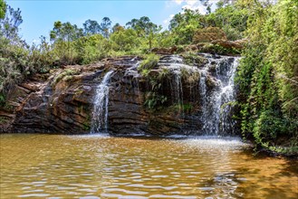 Water well formed by the waterfall embedded in the rainforest in Minas Gerais