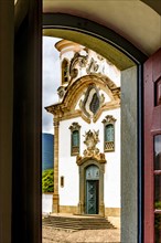 Baroque church facade seen through the window in the city of Mariana in the state of Minas Gerais