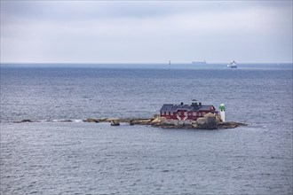 Typical tiny archipelago island with lighthouse and lighthouse keeper's house