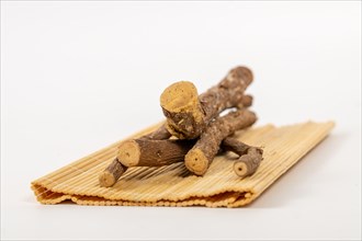 Pile of licorice roots sticks isolated on a white background
