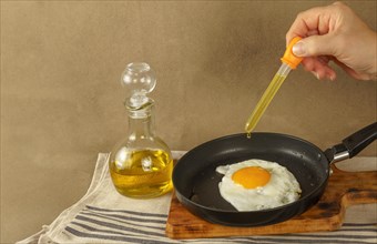 Woman frying an egg
