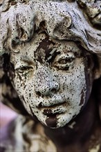 Weathered face of a figure at the Hygieia fountain in the town hall courtyard