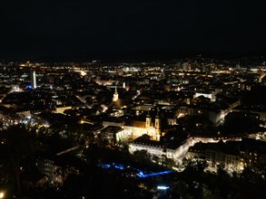 View of the city of Graz illuminated at night from the Schlossberg