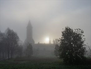 Church tower in the morning mist