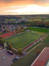 Football pitch in small village at sunset