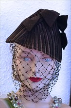 Head of a fashion doll from the 1920s with black net veil
