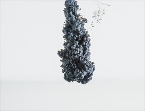 Abstract heavy gray ink drop falling