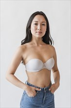 Asian female bra with hands pockets