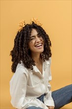 Black woman with flowers hair laughing