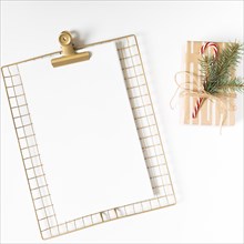 Clipboard with gift box white table