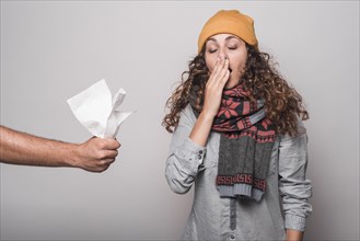 Close up hand giving tissue paper sick woman suffering from cold flu