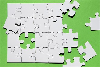 Close up puzzle piece green background