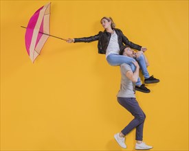 Couple floating with umbrella