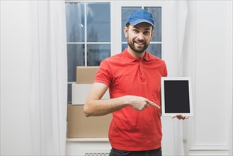 Delivery man pointing tablet