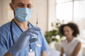 Doctor holding syringe with vaccine patient