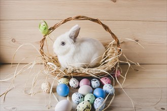 Easter eggs near rabbit basket