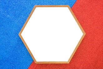 Empty wooden hexagon frame red blue background