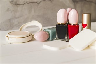 Face cosmetic compact makeup powder with sponges nail polish bottle lipstick table