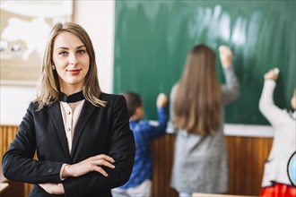 Female school teacher background blackboard students