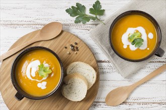 Flat lay bowls with pumpkin cream soup