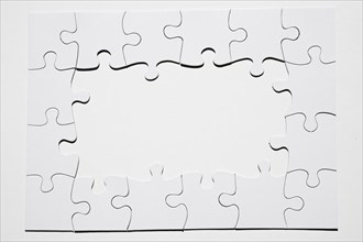 Frame made from white puzzle piece white background