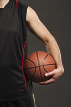 Front view basketball held by player close body