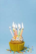 Front view cupcake with lit candles copy space