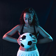 Front view fit woman with soccer ball