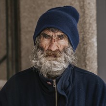 Front view homeless man with beard outdoors