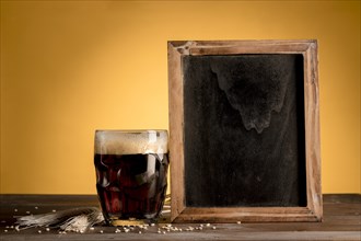 Glass beer putting blackboard wooden table
