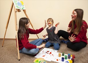 Happy girl with down syndrome woman painting