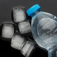 Ice cubes bottle water top view