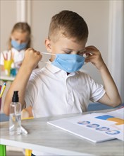 Kids putting his medical mask