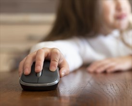 Little girl using computer mouse