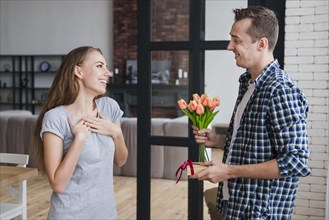 Male giving flowers gift wife