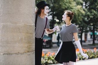 Male mime giving flower female mime