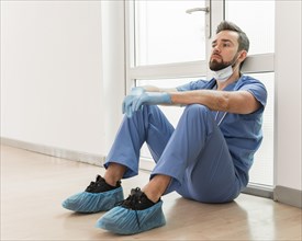 Male nurse tired after long day work