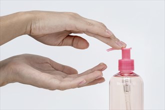 Person pouring liquid soap from bottle
