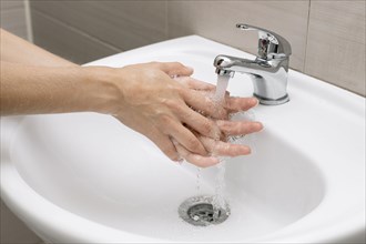 Person washing hands sink