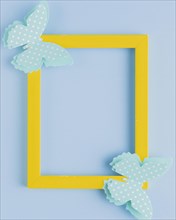 Polka dotted butterfly yellow border frame blue background