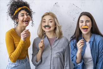 Portrait happy laughing women with mustaches