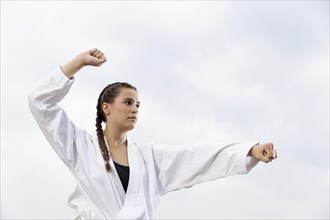 Portrait young girl exercising karate