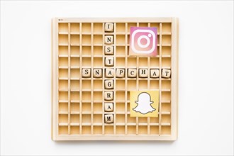 Scrabble wooden game showing instagram snapchat words with their icons