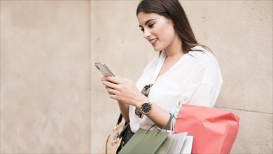 Shopping girl using her mobile phone