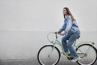 Side view woman riding her bike
